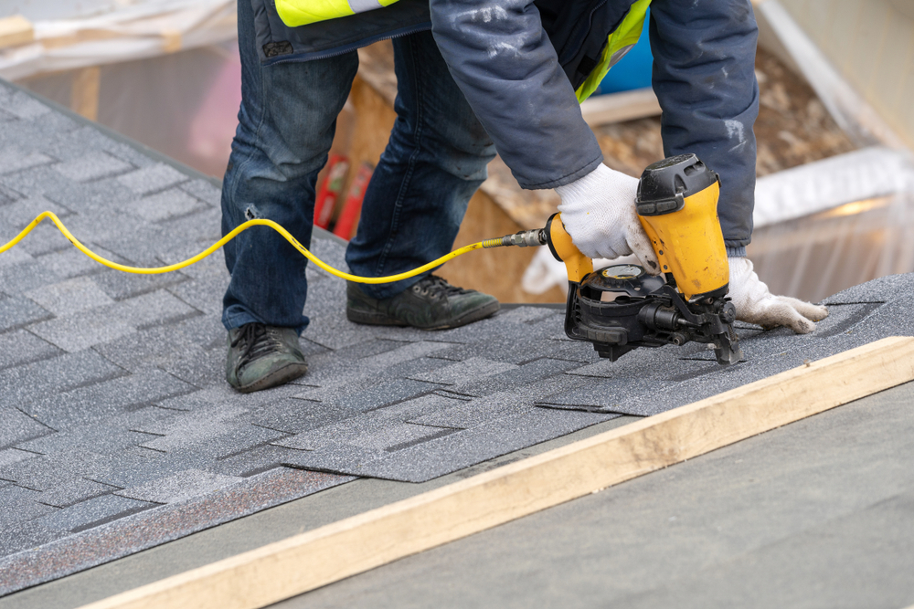 Local roofing contractors installing a new roof on a house