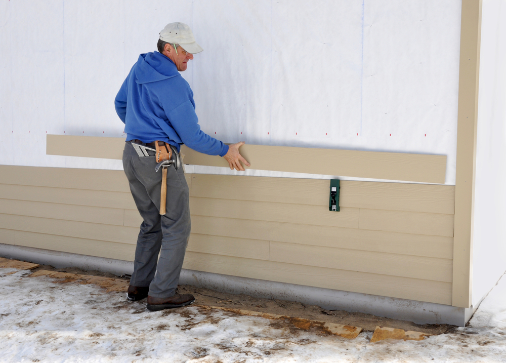 Professional contractor performing hardie backer board installation