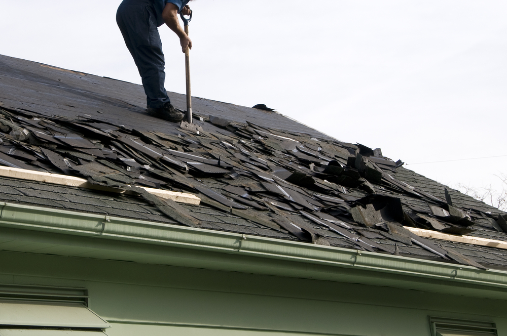 A professional performing roof removal on a house in Bucks County PA